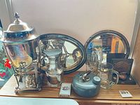 Full lot showing trophy urn, tray, vase, decanter, mugs, medallion