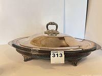 Full view of assembled silver-plated covered dish with handle lid and numbered tag