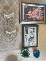 Lot overview: two framed prints, two glass star candle holders, two painted diyas