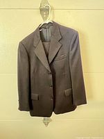 Full front view of black blazer on hanger