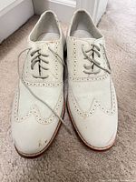 Top view of both shoes showing wingtip design and scuffs