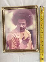 Full view of framed portrait with measuring tape showing height