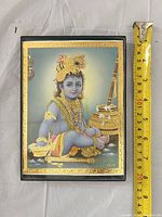 Front view with tape measure indicating 10 in height of framed print