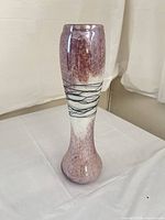 Full front view of the tall pink, white and black art glass vase