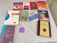 All 10 nursing books laid out on table
