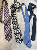 Front view of four silk neckties laid out side by side