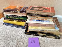 Two stacks of approximately ten spirituality, yoga and self-help books with visible titles and authors.