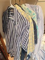 All six shirts hanging to show variety of patterns