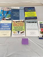 All seven paperback books laid out in two rows