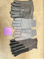 Overview of three pairs of gloves laid out
