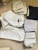 All six folded pants displayed on carpet
