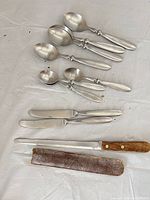 Full lot showing spoons, knives, honing rod and sheath