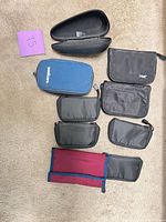Group shot of all pouches and cases laid out on carpet