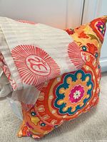 Pillow with scarf draped showing colors and pattern