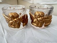 Front view showing cherub relief and gold accents on both votive holders