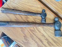 Both hammers full view on wooden surface
