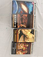 All four VHS tapes laid flat showing front covers