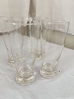 Four clear glass tumblers standing upright