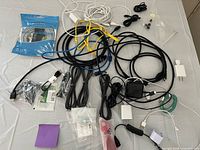 Overview of all assorted cables, chargers and accessories laid on table