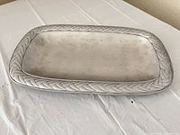 Full view of pewter tray on white surface