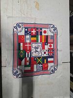 Full front view of square bandana showing complete flag pattern and Olympic graphics