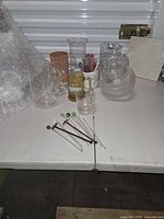 Group shot of all glassware, pitchers, mugs and stirrers on table