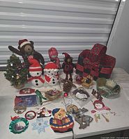 Full lot showing plush figures, baskets, tree, ornaments spread on table