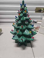 Front view of ceramic Christmas tree showing multicolor bulbs and shape