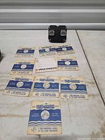 Viewer and 11 paper-sleeved reels arranged on surface