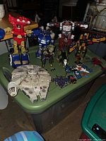 Overview of Millennium Falcon, six robot figures, accessory pieces on tote