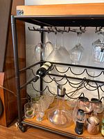 Close view of upper section with hanging stemware and wine racks