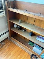 Left angle of bookshelf showing wood grain and shelf spacing