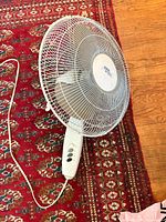 Full view of Cool Works fan head on rug, showing power cord