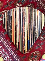 Front view of guitar pick wall art showing record spine design