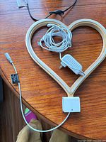 Entire wooden heart light with cord and adapter on tabletop