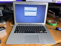 Front view of MacBook Air laptop powered on displaying macOS Utilities