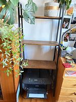 Front view of ladder bookshelf showing four shelves and frame.