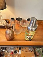 Overview showing shaker, pineapple, glasses, copper mug
