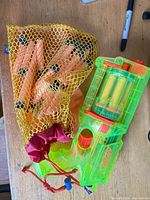 Blaster and mesh bag of darts overview