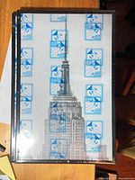 Front view showing three stacked 11x17 frames in shrink-wrap with sample poster