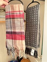 Both scarves hanging to show patterns and fringe