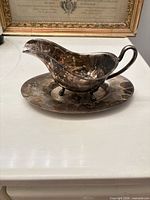 gravy boat on underplate front view showing tarnish