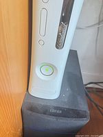 Front view of white Xbox 360 console standing vertically
