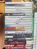 Stack of all Xbox 360 game cases showing spines