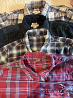 Five overlapping plaid long-sleeve button shirts