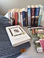 Overall lot showing FRYE throw, stack of books, magazines