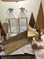 overview showing two lanterns, wood trees, welcome sign, scrap boards