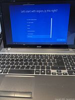 Open Acer laptop showing setup screen and keyboard