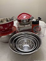Group view of colander, mixing bowls, casseroles, prep bowl, travel mug