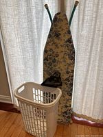 Ironing board, laundry basket with iron in front